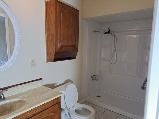 bathroom featuring a shower, toilet, vanity, and tile flooring