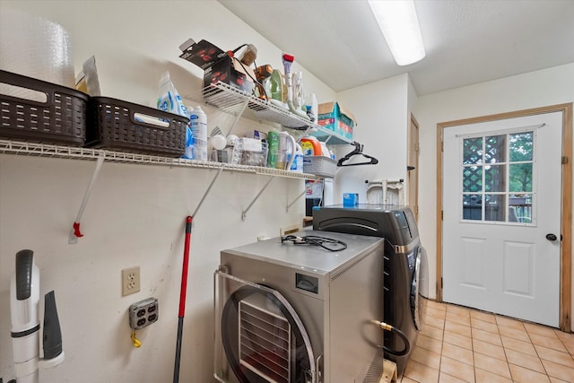 laundry area with hookup for a washing machine, light tile floors, and washing machine and clothes dryer