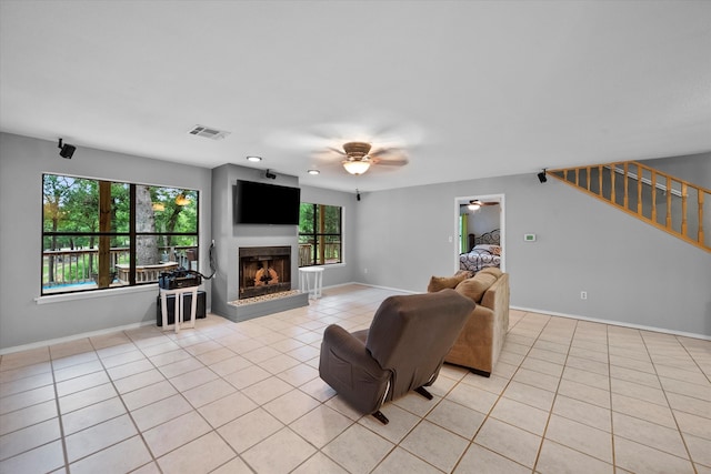 living room featuring ceiling fan and light tile flooring