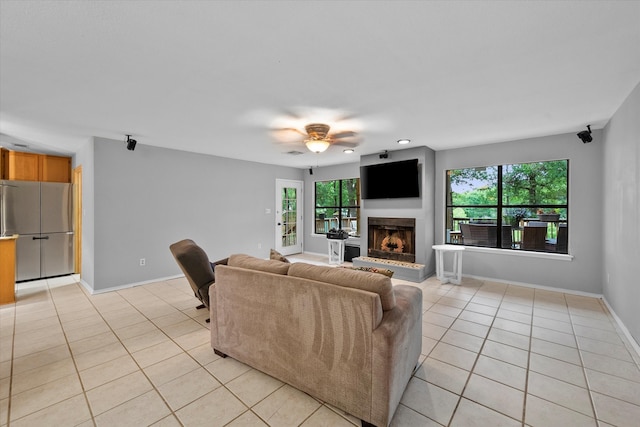 living room with ceiling fan and light tile floors