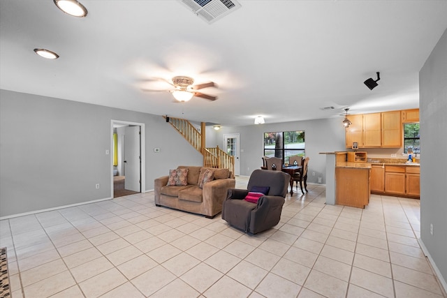 tiled living room with ceiling fan