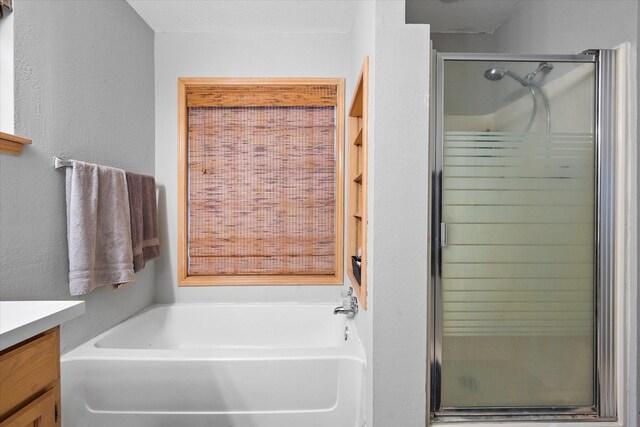 bathroom featuring independent shower and bath and vanity