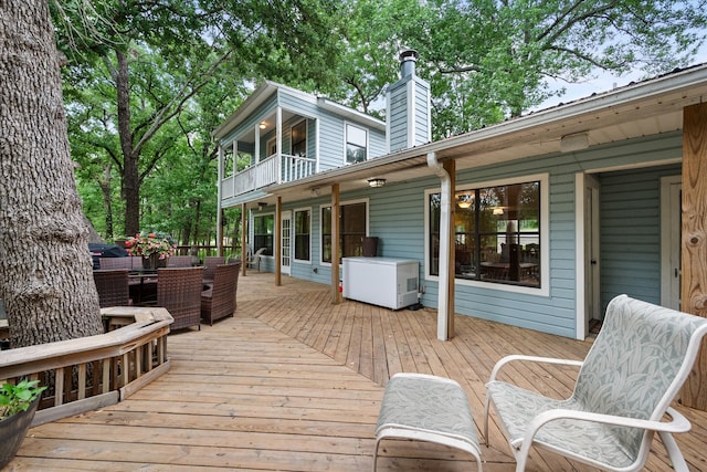 wooden terrace with an outdoor living space