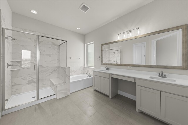 bathroom with tile floors, separate shower and tub, and double sink vanity