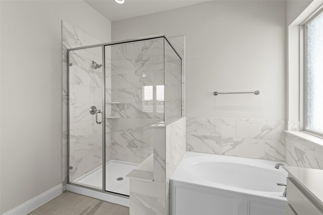 bathroom featuring separate shower and tub and plenty of natural light