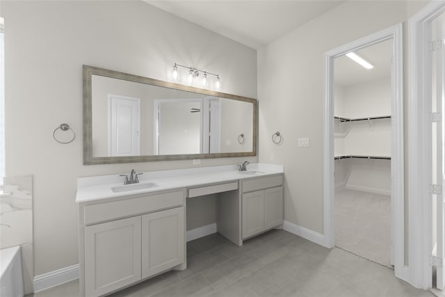 bathroom featuring vanity with extensive cabinet space, dual sinks, and tile floors