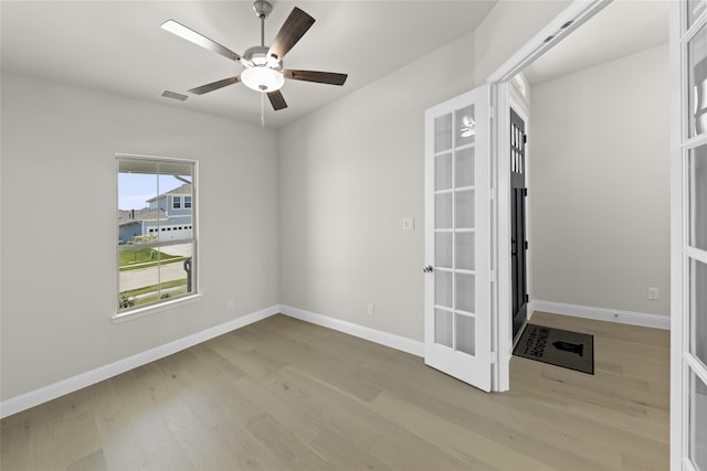 spare room with ceiling fan, light hardwood / wood-style flooring, and french doors