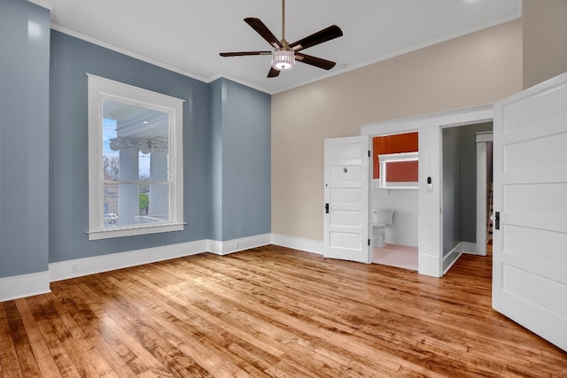 unfurnished bedroom with connected bathroom, ceiling fan, light wood-type flooring, and crown molding