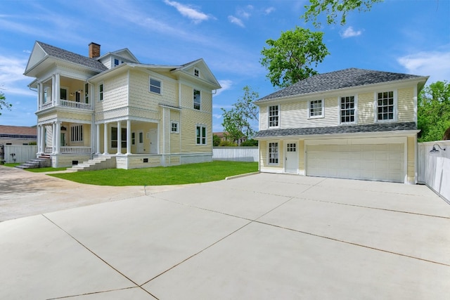 view of front of property featuring a front yard and a garage