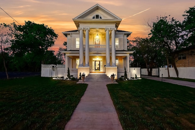 neoclassical / greek revival house featuring a lawn and covered porch