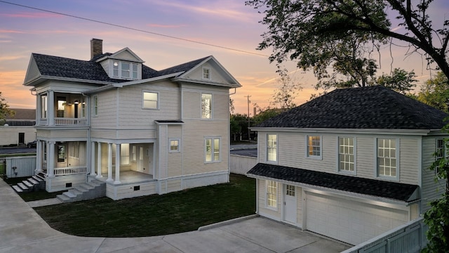 view of front of home featuring a balcony and a garage