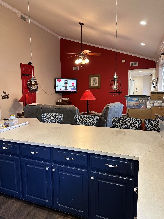 kitchen featuring ceiling fan, dark hardwood / wood-style floors, vaulted ceiling, and decorative light fixtures