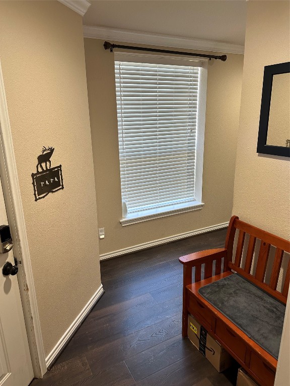 dining space with ornamental molding and dark hardwood / wood-style flooring