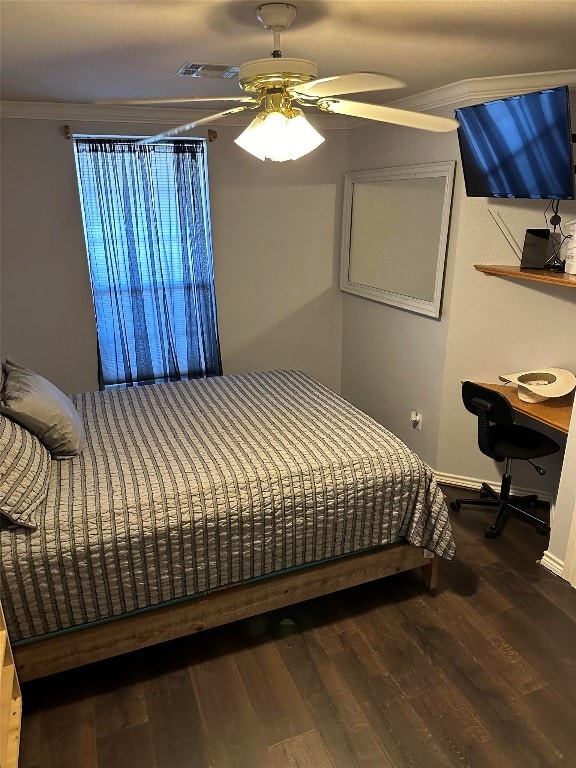 bedroom featuring ceiling fan, ornamental molding, and dark wood-type flooring