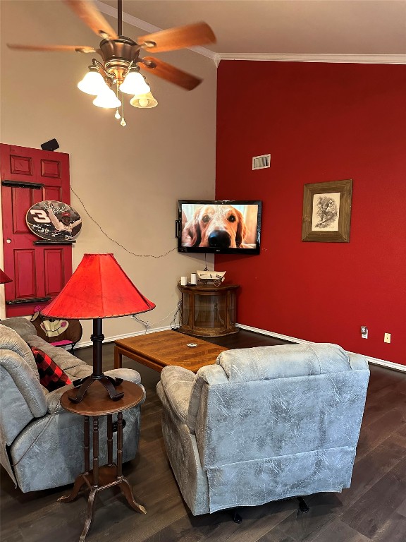 living room featuring crown molding, dark hardwood / wood-style flooring, and ceiling fan