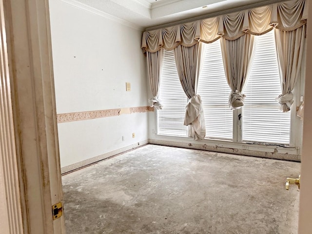 spare room with crown molding and concrete flooring