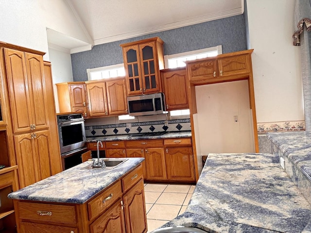 kitchen featuring appliances with stainless steel finishes, tasteful backsplash, crown molding, lofted ceiling, and sink