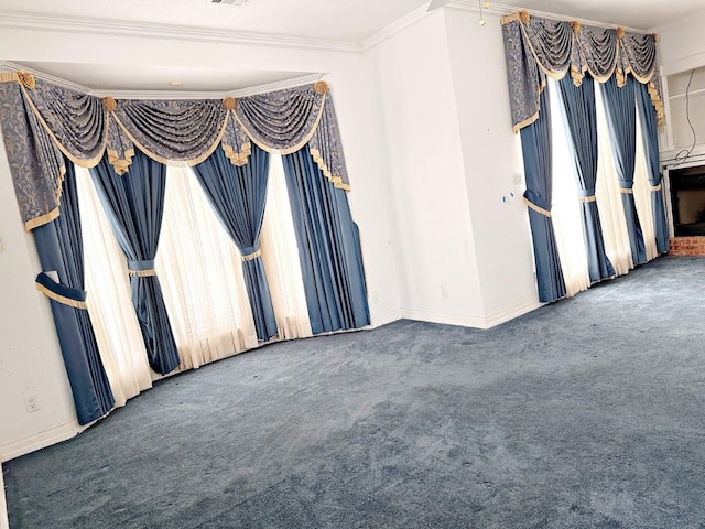 empty room featuring crown molding and dark carpet