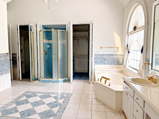 bathroom featuring vanity, shower with separate bathtub, tile flooring, and ornamental molding