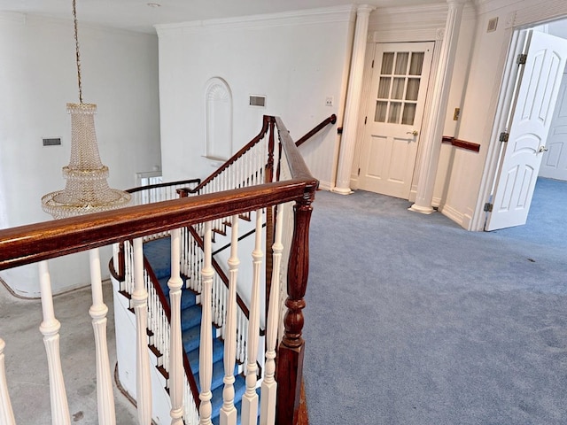 stairway featuring dark carpet and crown molding