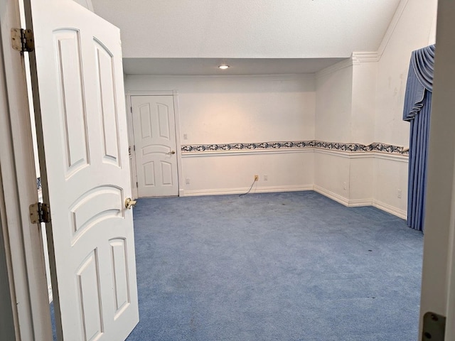 carpeted empty room featuring a textured ceiling and crown molding