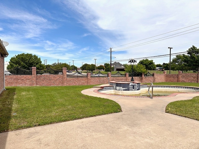 view of home's community with a yard