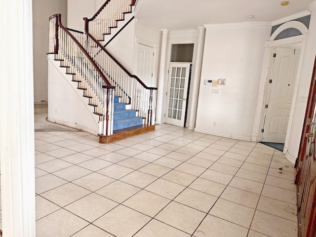 tiled entrance foyer featuring ornamental molding