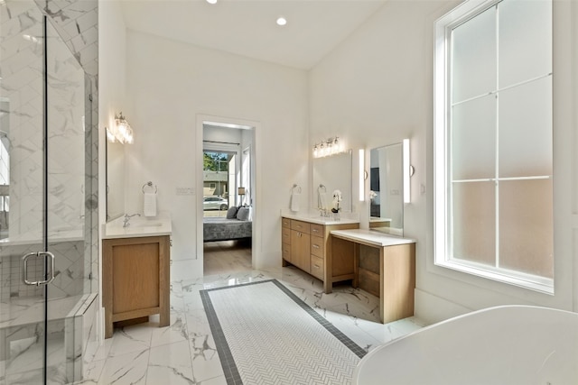 bathroom featuring vanity, shower with separate bathtub, and a wealth of natural light