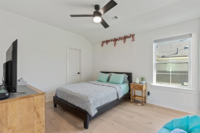 bedroom featuring lofted ceiling, ceiling fan, and light hardwood / wood-style flooring