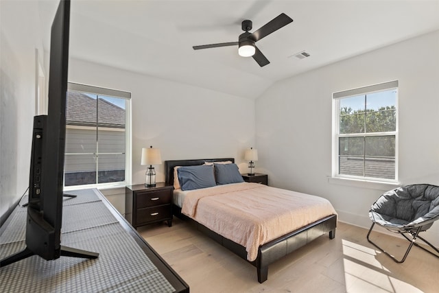 bedroom featuring light wood-type flooring, lofted ceiling, and ceiling fan