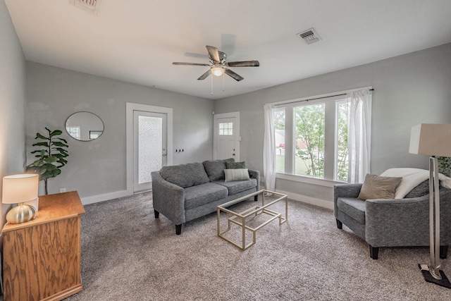 carpeted living room with ceiling fan