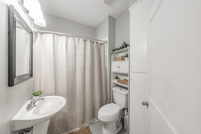 bathroom featuring tile patterned floors, sink, and toilet