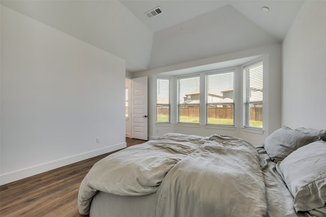 bedroom featuring dark hardwood / wood-style flooring and lofted ceiling