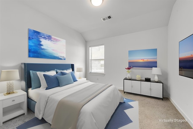 bedroom featuring light colored carpet and lofted ceiling