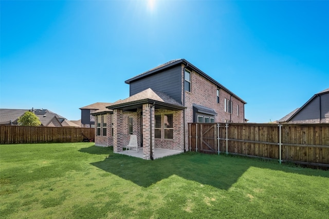 back of property with a lawn and a patio area