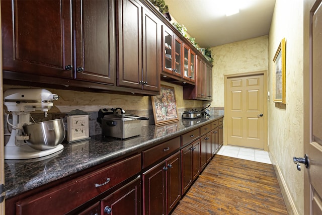 kitchen featuring dark stone countertops and dark hardwood / wood-style floors