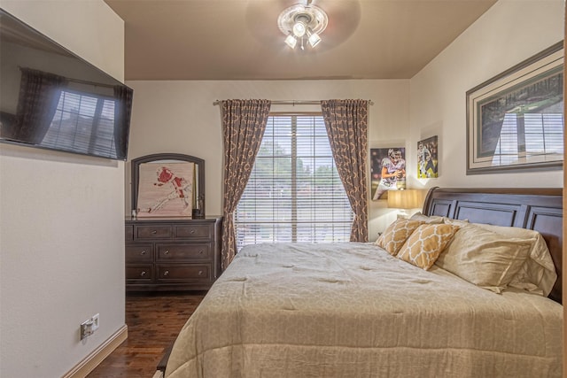 bedroom featuring ceiling fan and dark wood-type flooring