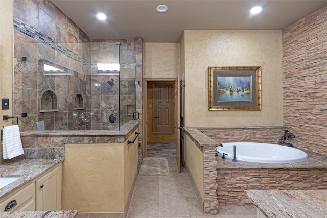 bathroom with plus walk in shower, tile patterned flooring, and vanity