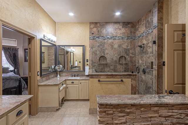 bathroom with tile patterned floors, vanity, and a shower with shower door