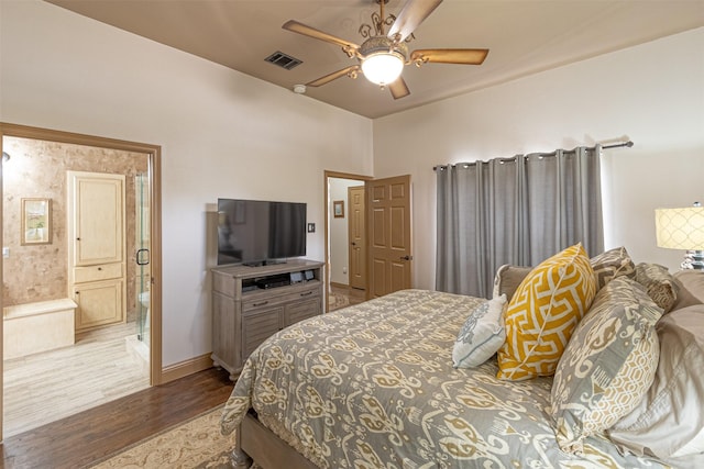 bedroom with ceiling fan, hardwood / wood-style floors, and ensuite bath