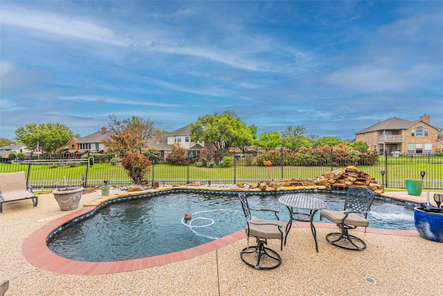 view of swimming pool featuring a patio area, a lawn, and pool water feature