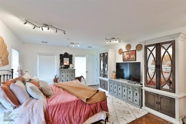 bedroom featuring track lighting