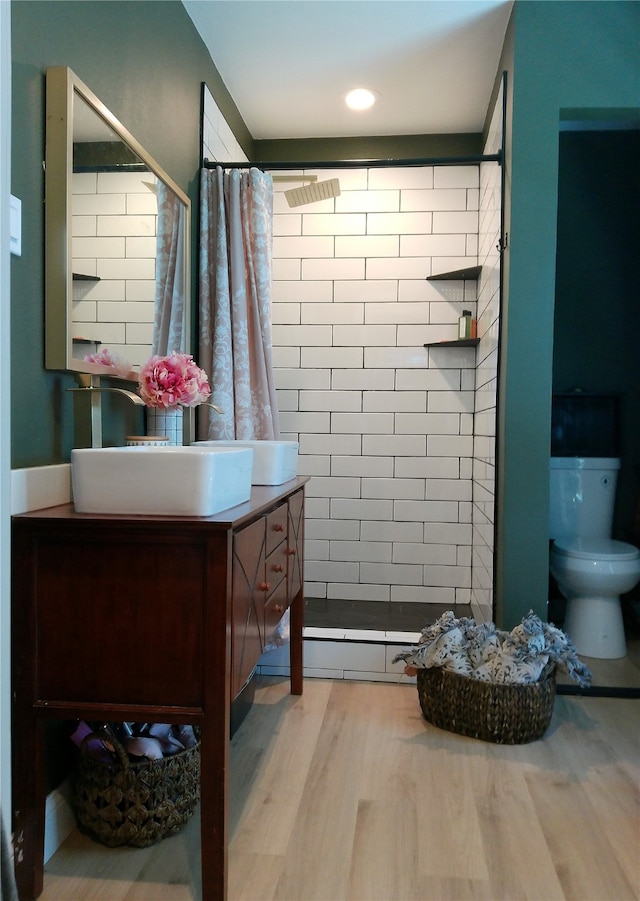 bathroom with vanity, toilet, and hardwood / wood-style floors