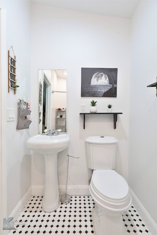 bathroom featuring tile floors and toilet