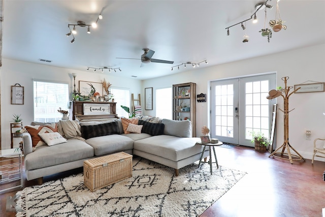 living room featuring plenty of natural light, ceiling fan, french doors, and track lighting