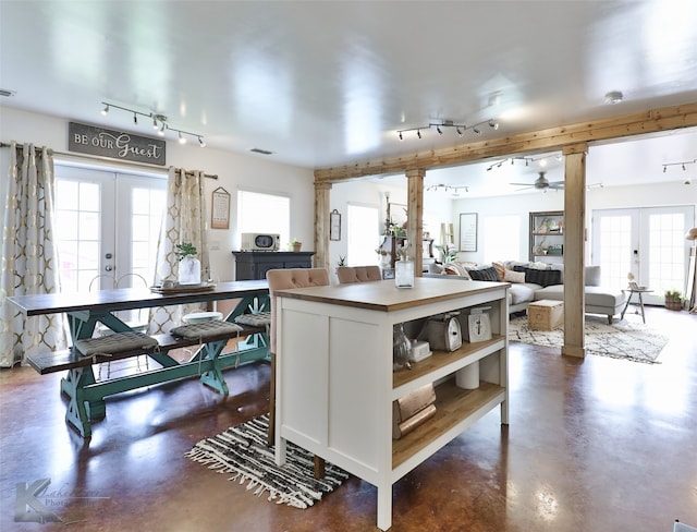 kitchen with track lighting, white cabinets, ceiling fan, and french doors