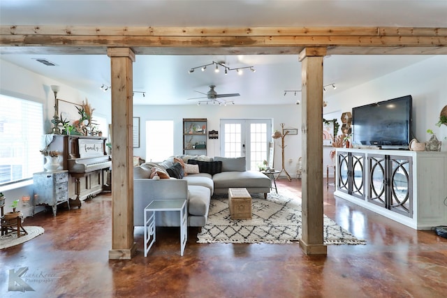 living room with ceiling fan, concrete flooring, track lighting, and french doors