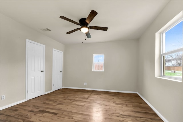 spare room featuring dark hardwood / wood-style floors and ceiling fan