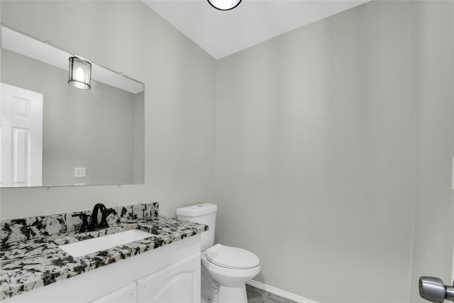 bathroom with tile floors, toilet, and vanity