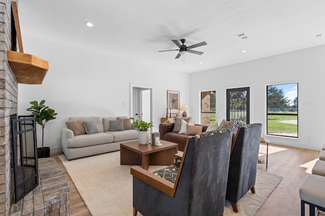 living room with light wood-type flooring and ceiling fan